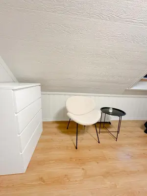 a white chair and a table in a room at Central stay apartment - 401 in Bergen