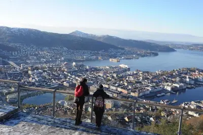 two people standing on top of a hill overlooking a city at Central stay apartment - 401 in Bergen