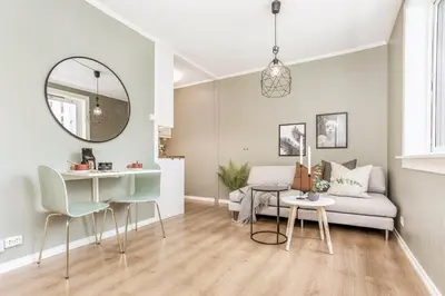 a living room with a couch and a table at Charming studio apartment in Bergen