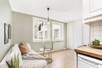 a living room with a couch and a table at Charming studio apartment in Bergen