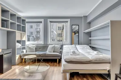 a living room with a bed and a couch at Cozy Studio Retreat in Bergen