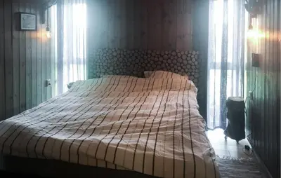 a bedroom with a bed with a striped comforter at Stunning Home In Lensvik With Wifi in Lensvik
