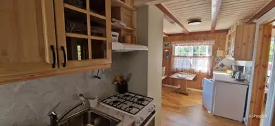 a kitchen with a stove and a white refrigerator at Vesletun in Balestrand
