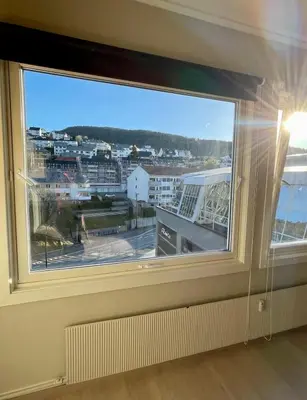 a window with a view of a city at Modern apartment ONLY 5 minutes from City Centre in Bergen