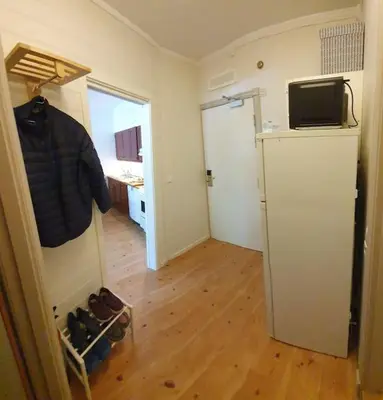 a room with a room with a refrigerator and a hallway at Fin leilighet i Geilo sentrum - kort vei til alt in Geilo