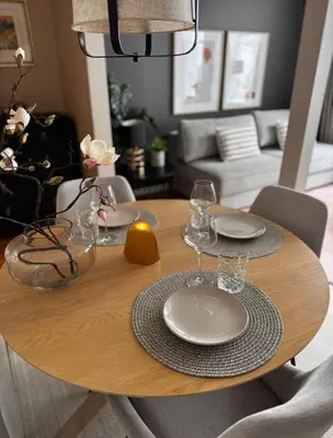 a wooden table with plates and wine glasses on it at The DreamHouse - inner City Center - Old Town in Bergen