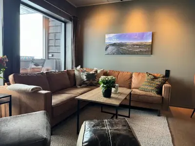 a living room with a couch and a table at Riddertunet Beitostølen in Beitostøl