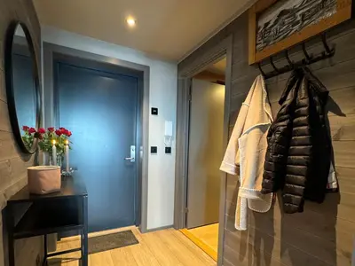 a bathroom with a hallway with a door and a mirror at Riddertunet Beitostølen in Beitostøl