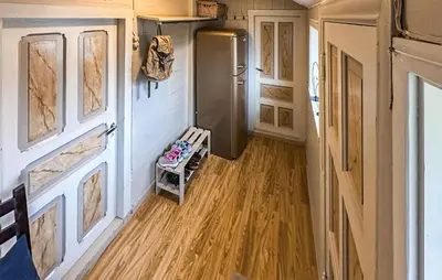 a kitchen with a refrigerator and a wooden floor at 3 Bedroom Stunning Home In Vikebygd in Vikebygd
