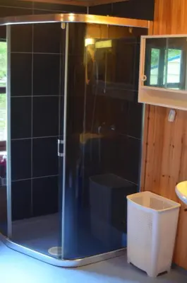 a shower with a glass door in a bathroom at Bay View Island Room - Svanøy in Svanøy