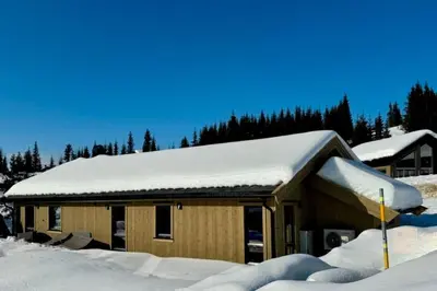 a house with snow on top of it at New cabin at Skeikampen, perfect for families! in Svingvoll