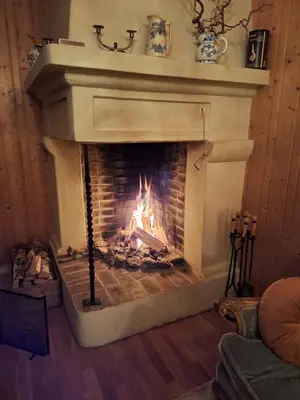 a fireplace with a fire in it in a room at Hurdal Gjestegård in Hurdal