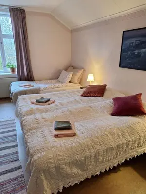 a bedroom with two beds with towels on them at Hurdal Gjestegård in Hurdal