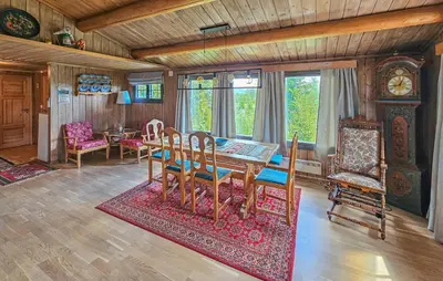 a dining room with a table and chairs and a clock at Beautiful Home In Gol With Kitchen in Gol