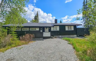 a black house with a gravel driveway in front of it at Beautiful Home In Gol With Kitchen in Gol