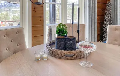 a wooden table with a basket and glasses on it at Awesome Home In Stryn in Stryn