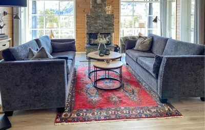 a living room with two couches and a red rug at Awesome Home In Stryn in Stryn