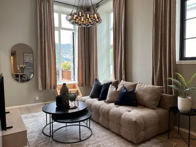 a living room with a couch and a table at Høyegaarden in Bergen