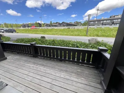 a wooden bench sitting on a porch at Relaxing Retreat With Two Terraces in Beitostøl