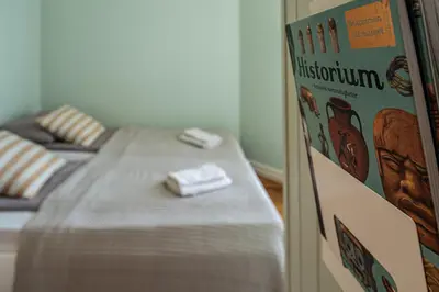 a room with a bed with a book on the wall at Sunny apartment in Ålesund city in Ålesund