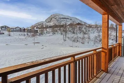 a winter view of a mountain from the porch of a cabin at Cozy Apartment close to Hovden alpine centre in Hovden