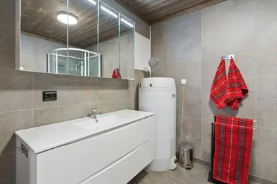 a bathroom with a white sink and a mirror at Cozy Apartment close to Hovden alpine centre in Hovden