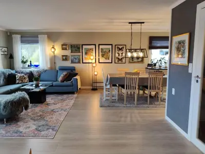 a living room with a blue couch and a table at Nearby Bergen, Midtunlia 27d in Bergen