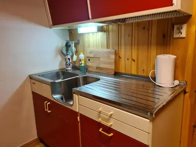 a kitchen with a sink and a counter top at Hyttepreget overnattingssted in Geilo