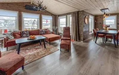 a living room with a couch and a table at 4 Bedroom Awesome Home In Vøringsfoss in Garden