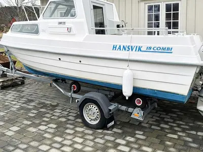 a boat on a trailer in front of a house at 4 person holiday home in Lysøysundet in Teksdal