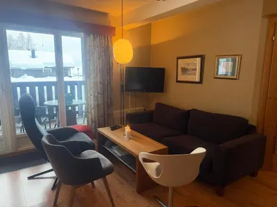 a living room with a couch and a table at Cozy Ground-Floor Apartment In Beitostølen in Beitostøl