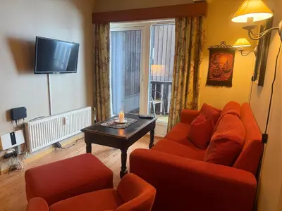 a living room with a couch and two chairs and a table at Ideal Base For Exploring 2 Bedrooms & Balcony in Beitostøl