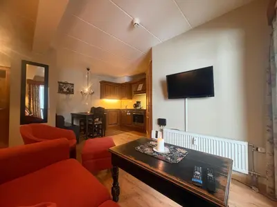 a living room with a couch and a table at Ideal Base For Exploring 2 Bedrooms & Balcony in Beitostøl