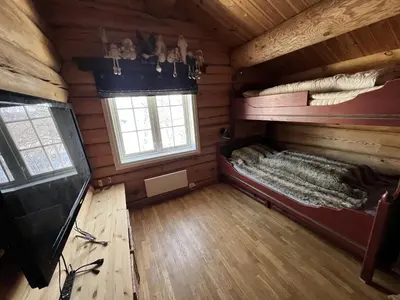 an empty room with a bed in a cabin at Geilo centrum - cozy apartment - central location in Geilo