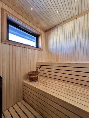 a sauna with a tub and a window in it at Golsfjellet - new modern cabin with fantastic view in Golsfjellet