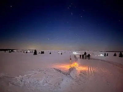 a group of people walking in the snow at night at Golsfjellet - new modern cabin with fantastic view in Golsfjellet