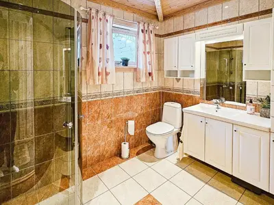 a bathroom with a toilet and a sink and a shower at 6 person holiday home in Bygstad in Bygstad