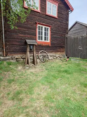 a wooden house with a bench in front of it at Private pearl in downtown Røros in Røros