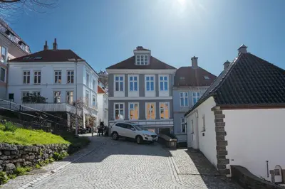a white car parked on a street with buildings at Experience the luxury lifestyle 100m from Bryggen! in Bergen