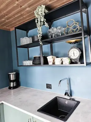 a kitchen with a sink and a shelf with dishes at Cozy Mountain Cottage with beautiful views & Sauna in Beitostøl