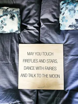 a sign sitting on top of a bed at Cozy Mountain Cottage with beautiful views & Sauna in Beitostøl