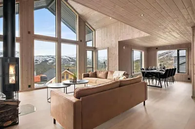 a living room with a couch and a table at Hytte med fjellutsikt til nydelig natur in Sogndal