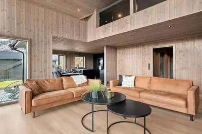 a living room with a couch and a table at Hytte med fjellutsikt til nydelig natur in Sogndal