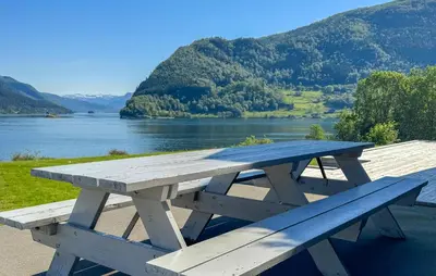 a picnic table with a view of a lake at 5 Bedroom Lovely Home In Ølensvåg in Vaka