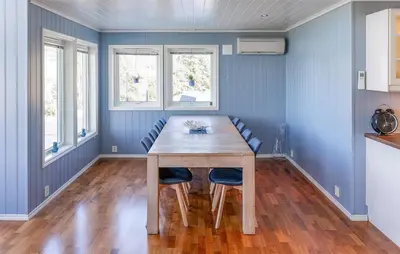 a dining room with a wooden table and chairs at 5 Bedroom Lovely Home In Ølensvåg in Vaka