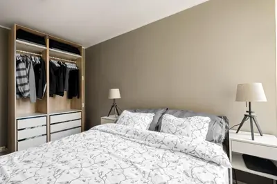 a bedroom with a bed and a closet at Bergen Beds Apartments I Luxury 250m from Bryggen in Bergen