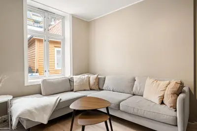 a living room with a couch and a window at Bergen Beds Apartments I Luxury 250m from Bryggen in Bergen