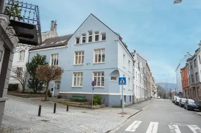 a blue and white building on a city street at Your Local Bergen Dream In The Heart Of The city in Bergen