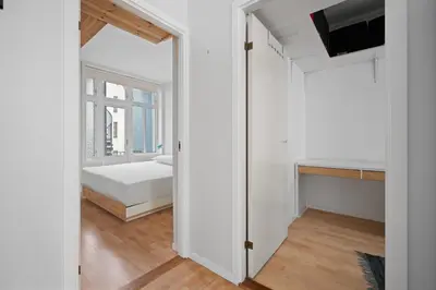 a small bedroom with a bed and a window at Your Local Bergen Dream In The Heart Of The city in Bergen