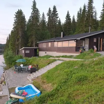 Idyllic lakeside cabin with private beach and boat